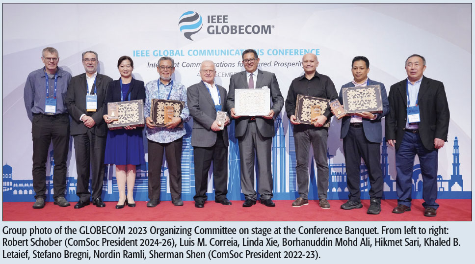 Group photo of the GLOBECOM 2023 Organizing Committee on stage at the Conference Banquet. From left to right: Robert Schober (ComSoc President 2024-26), Luis M. Correia, Linda Xie, Borhanuddin Mohd Ali, Hikmet Sari, Khaled B. Letaief, Stefano Bregni, Nordin Ramli, Sherman Shen (ComSoc President 2022-23).