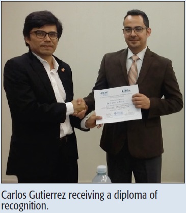 Carlos Gutierrez receiving a diploma of recognition.