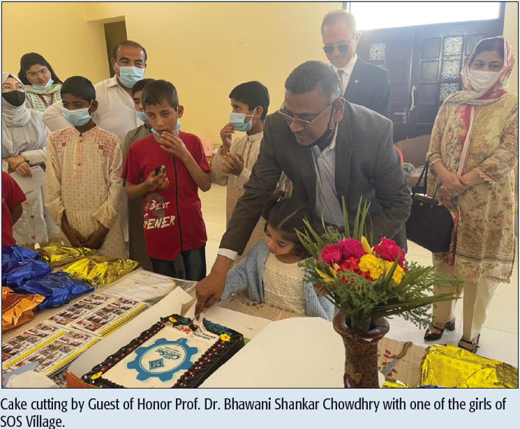 Cake cutting by Guest of Honor Prof. Dr. Bhawani Shankar Chowdhry with one of the girls of SOS Village.